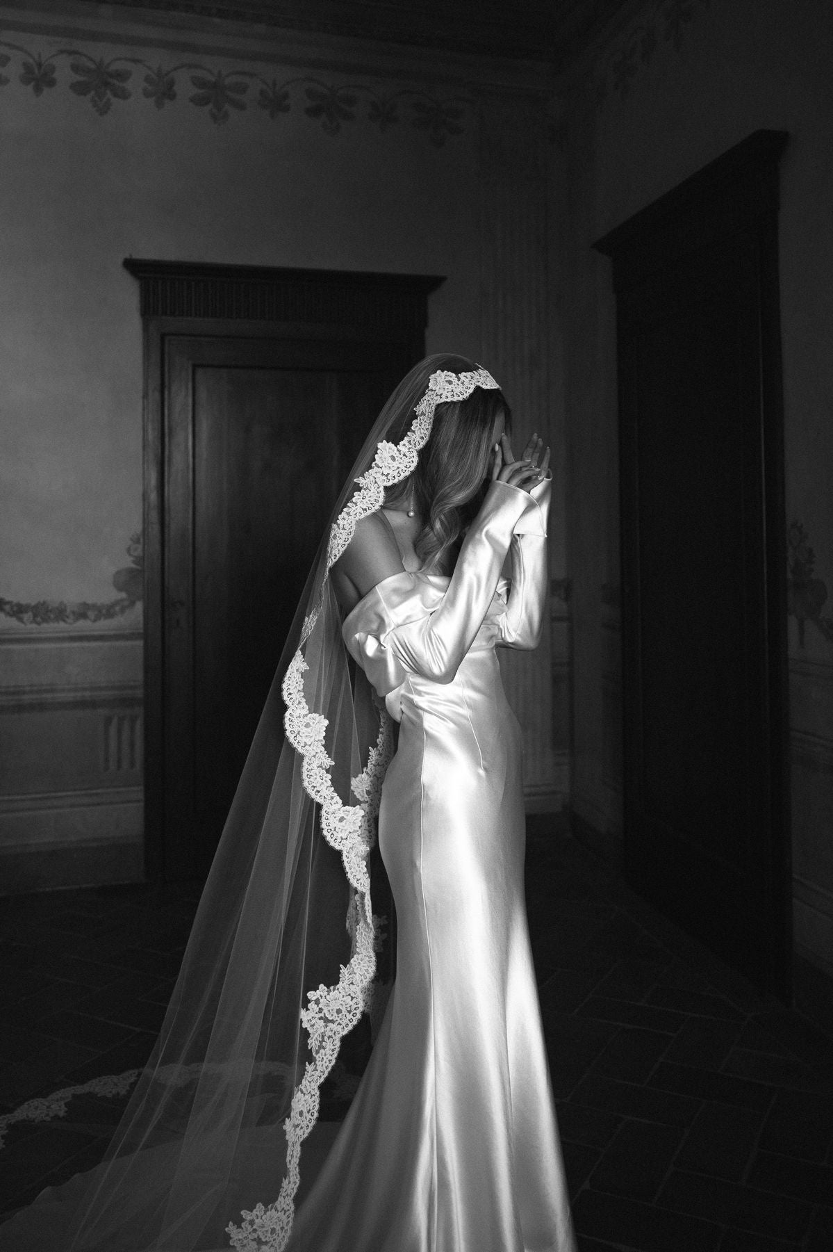 Bride with her hair down in soft waves wearing a cathedral wedding veil for a romantic look