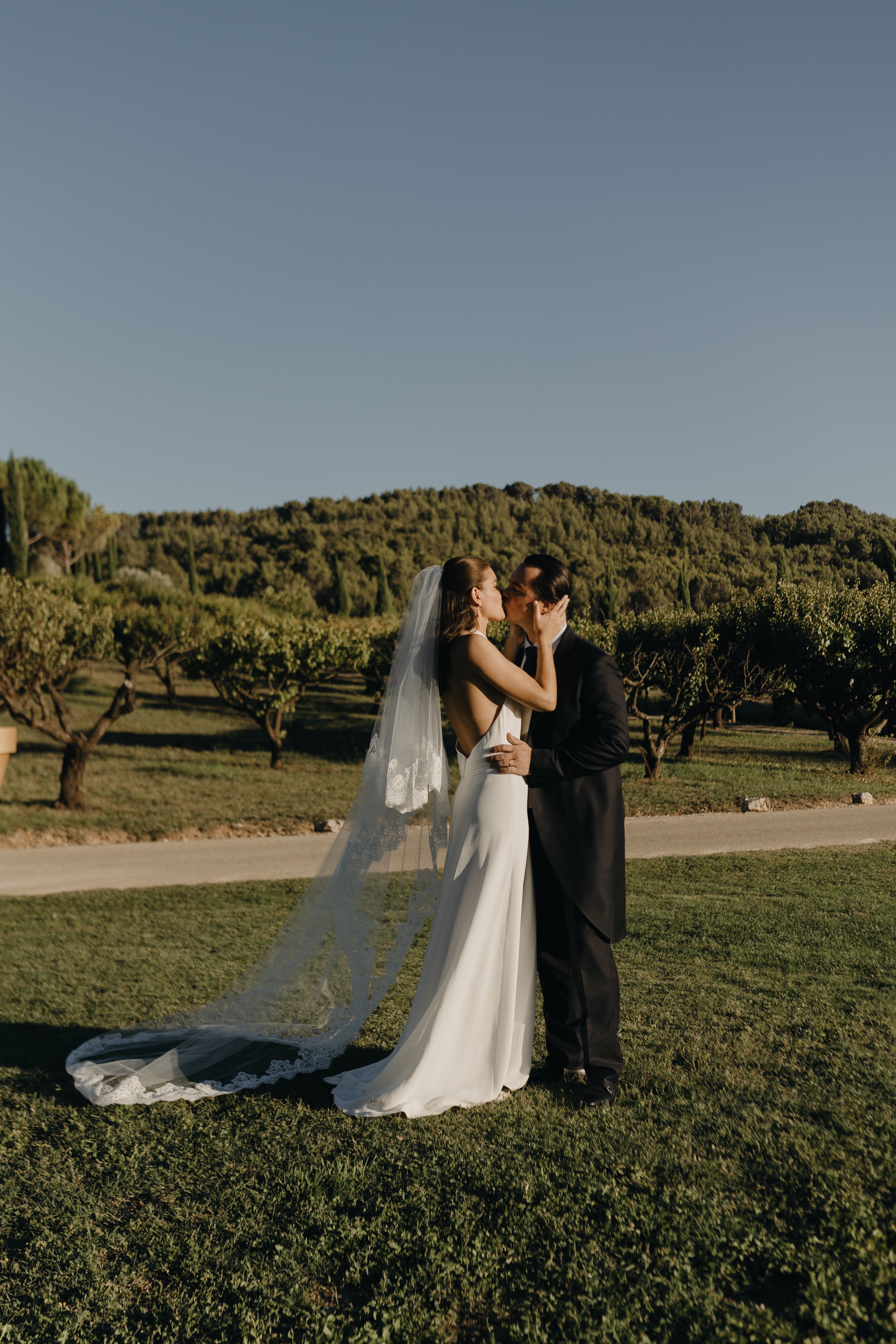 Backless wedding dress styled with a lace bridal veil