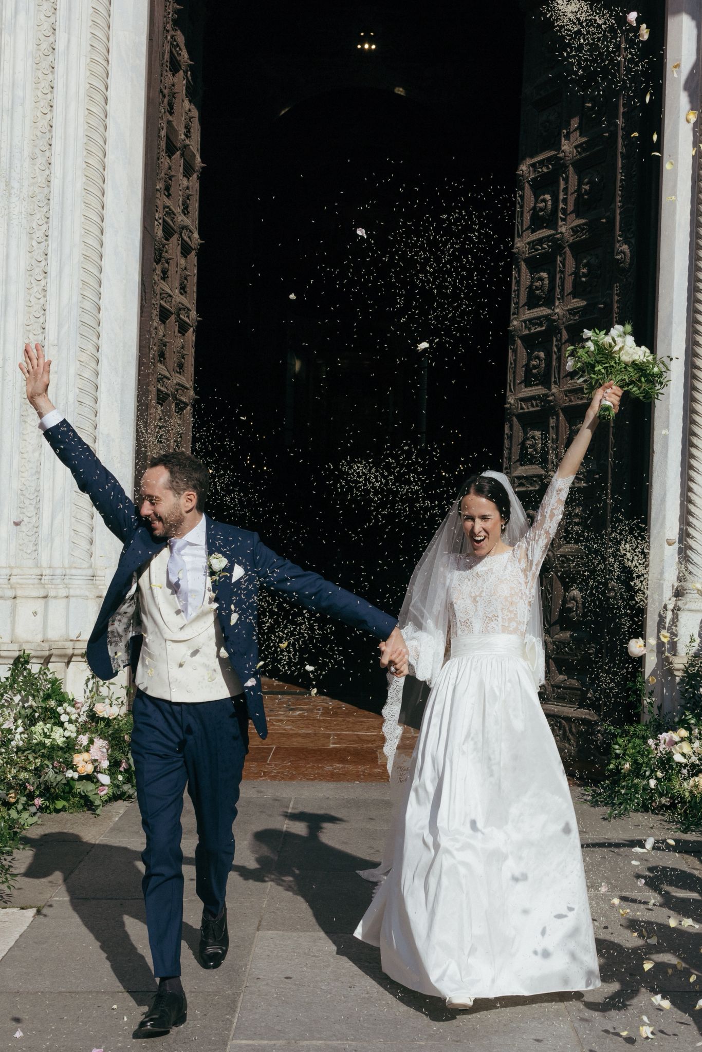Catholic bride wearing a lace wedding veil outside a church after the wedding ceremony