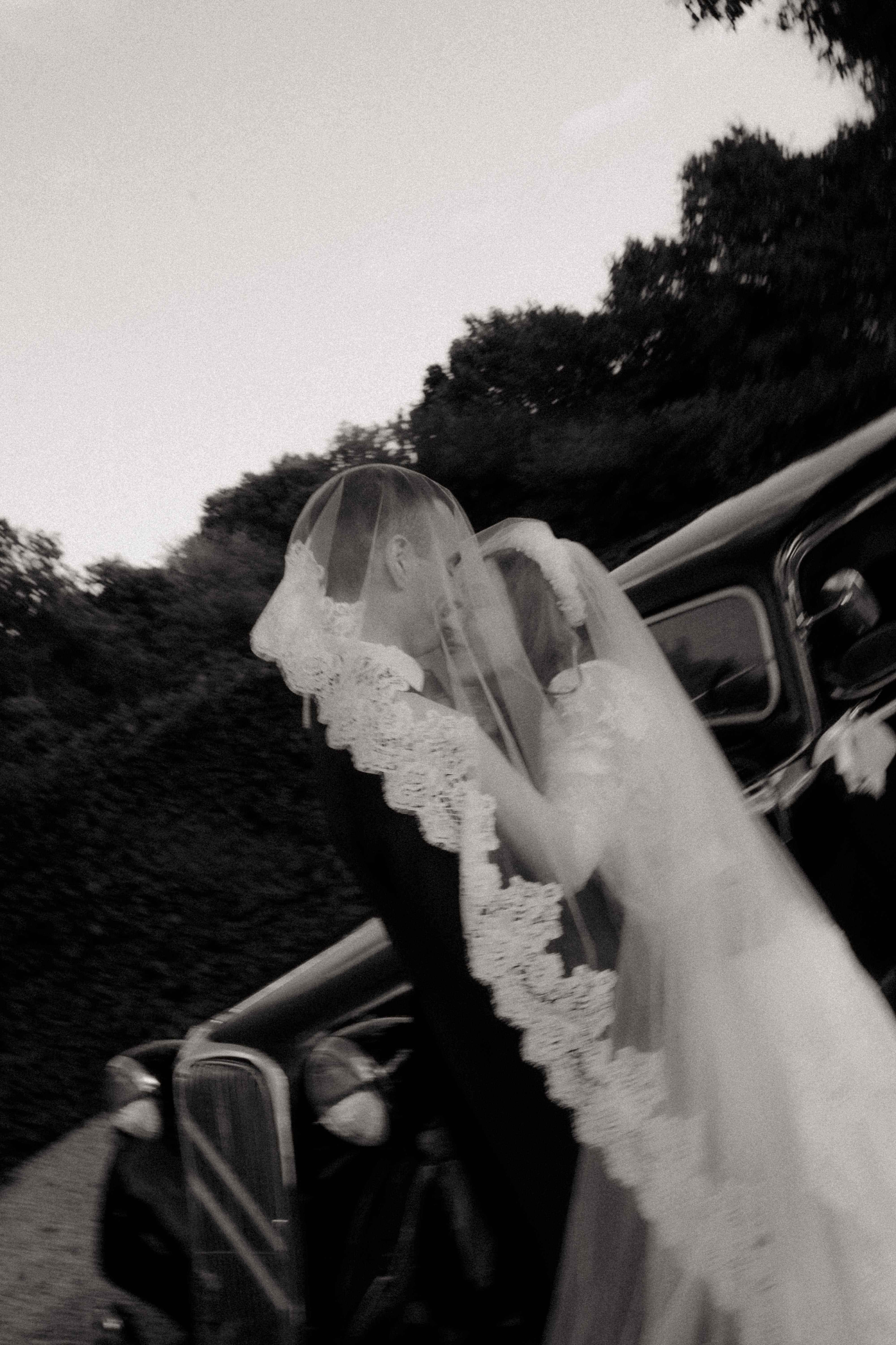 Groom and bride under bridal veil on the day of their wedding