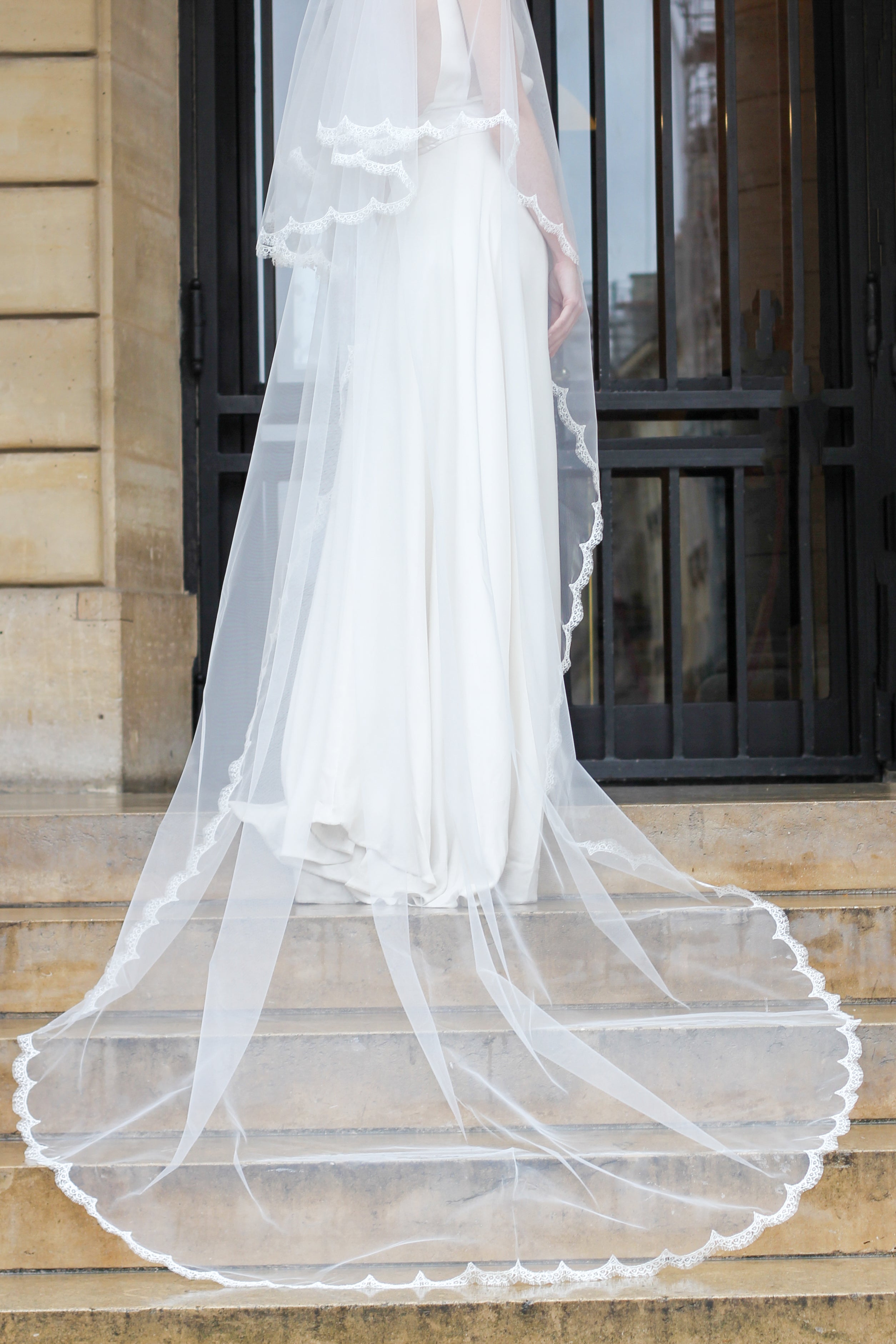 Flowing cathedral veil mounted on a copper comb, styled with an updo