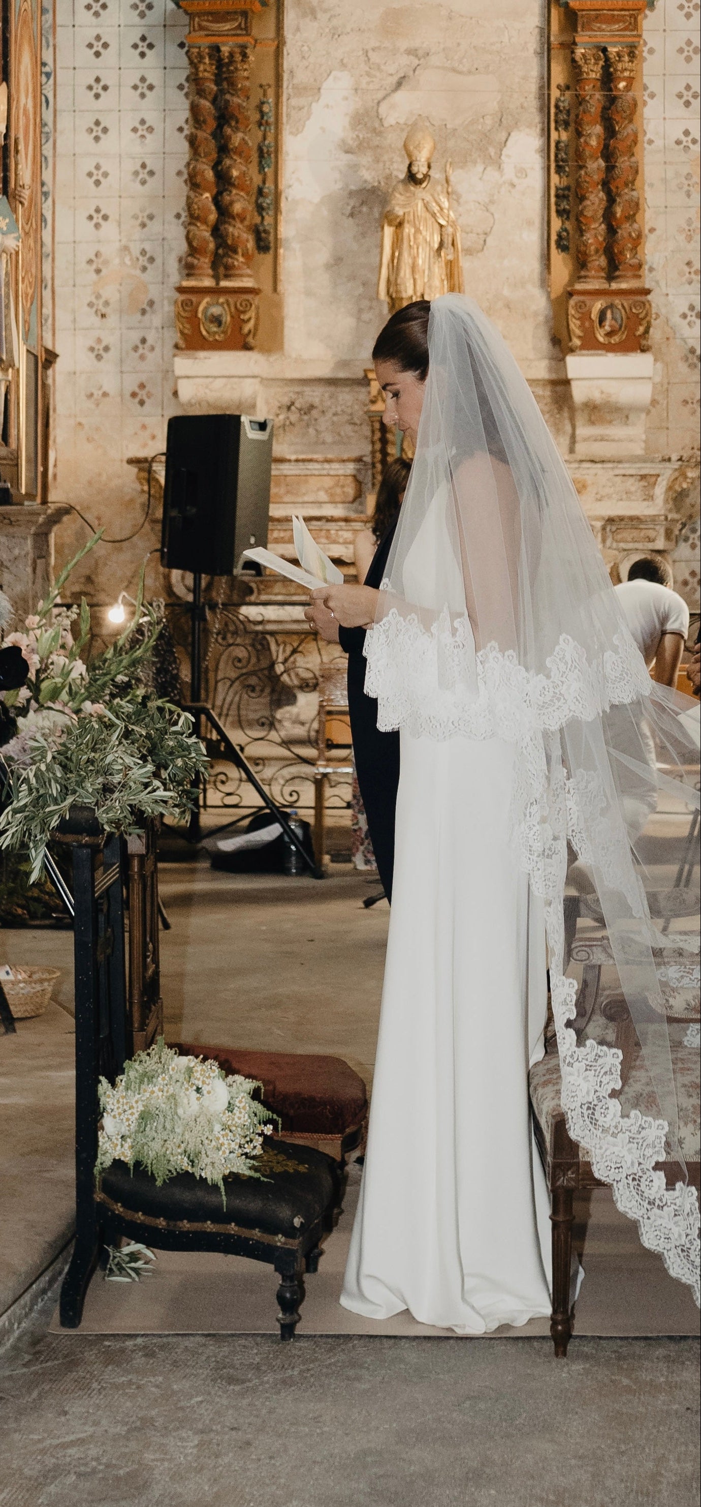Modern minimalist bride wearing a lace blusher wedding veil with a halter neckline dress