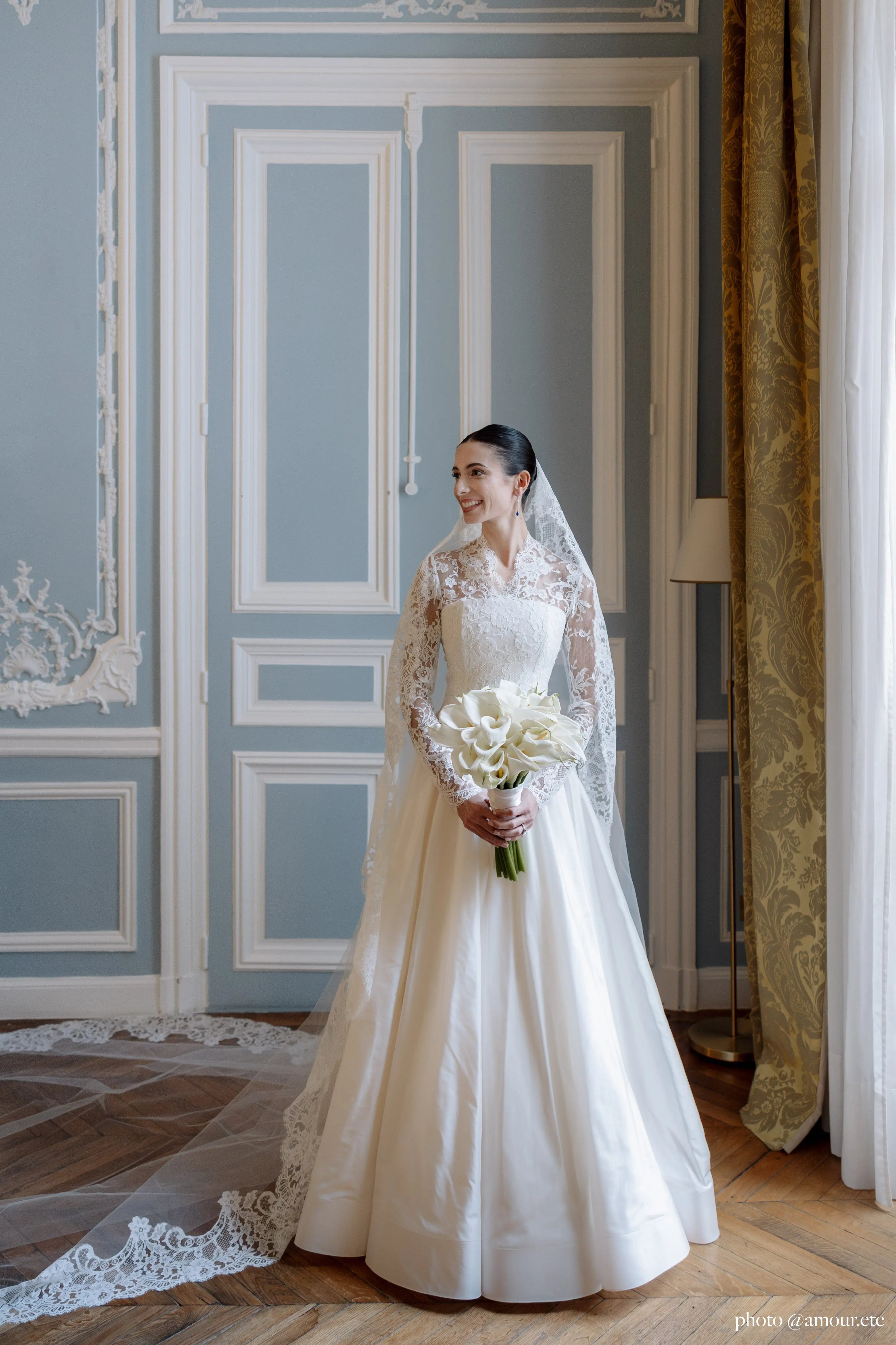 Bride in Paris wearing a lace wedding dress and wedding veil.