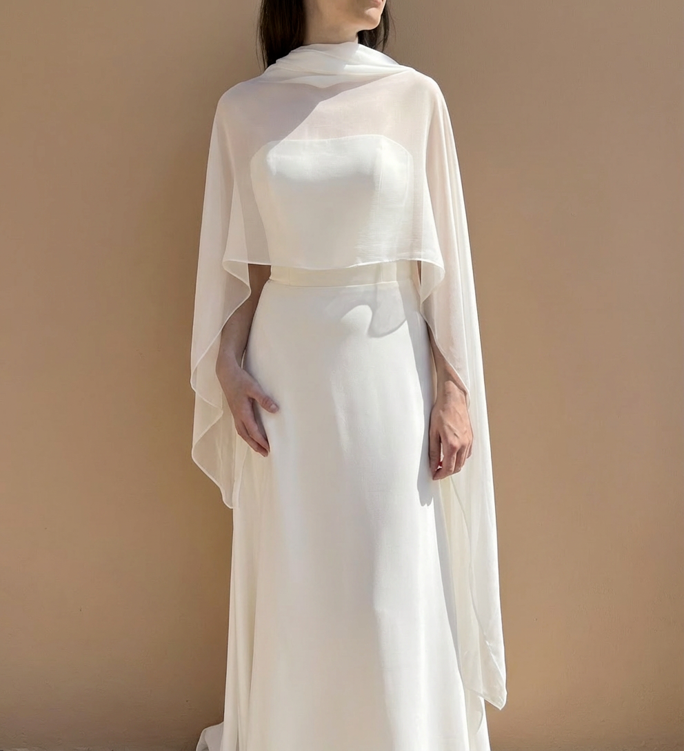 Bride wearing a natural white silk wedding shawl wrap
