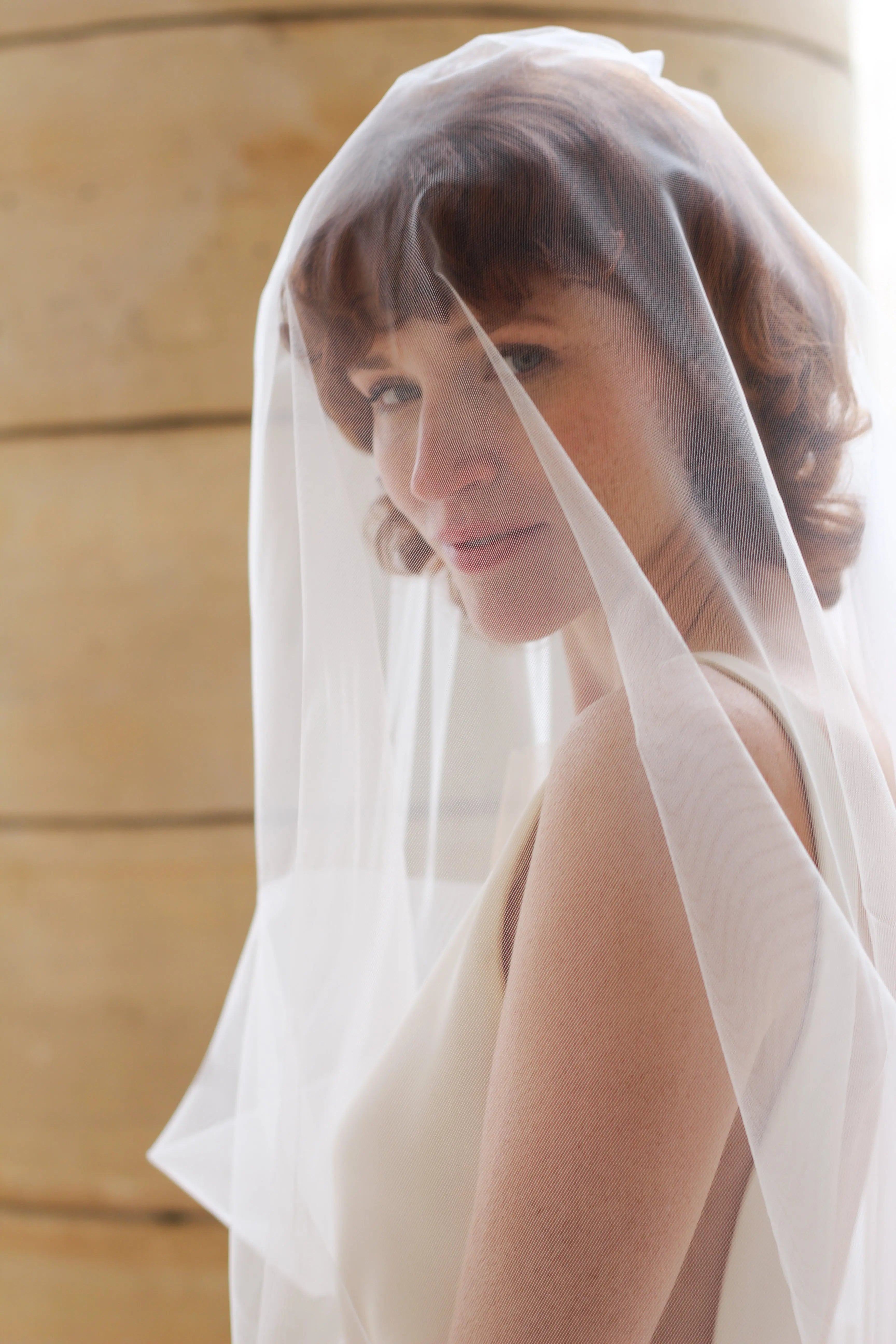 Detailed view of the T'Aimer bridal veil’s tulle, highlighting the fine craftsmanship and luxurious texture.