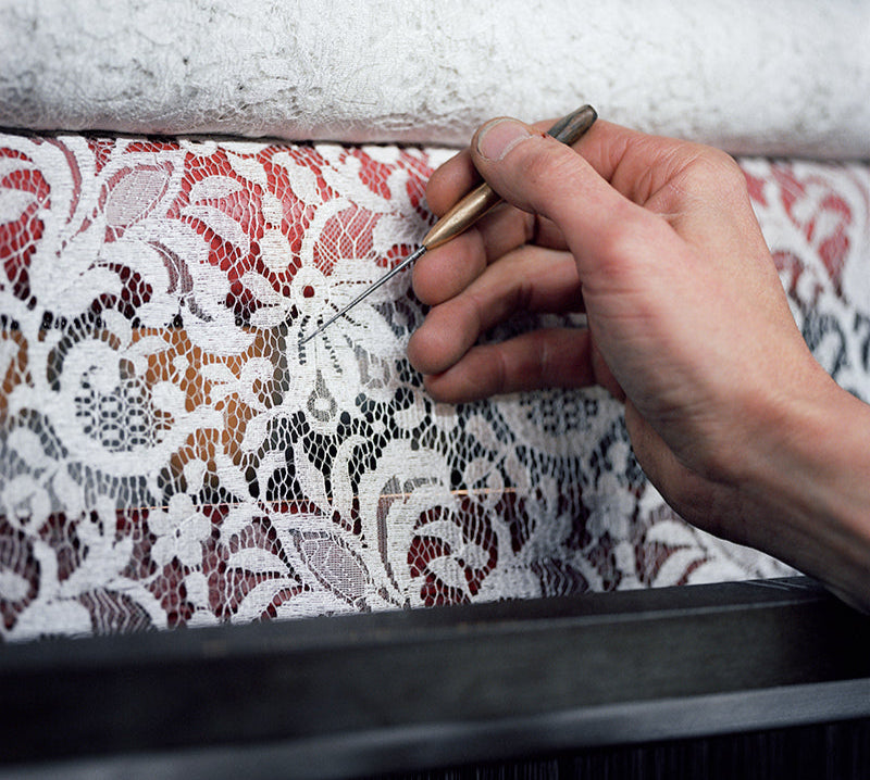 Hands creating Calais lace on a leavers weaving machine