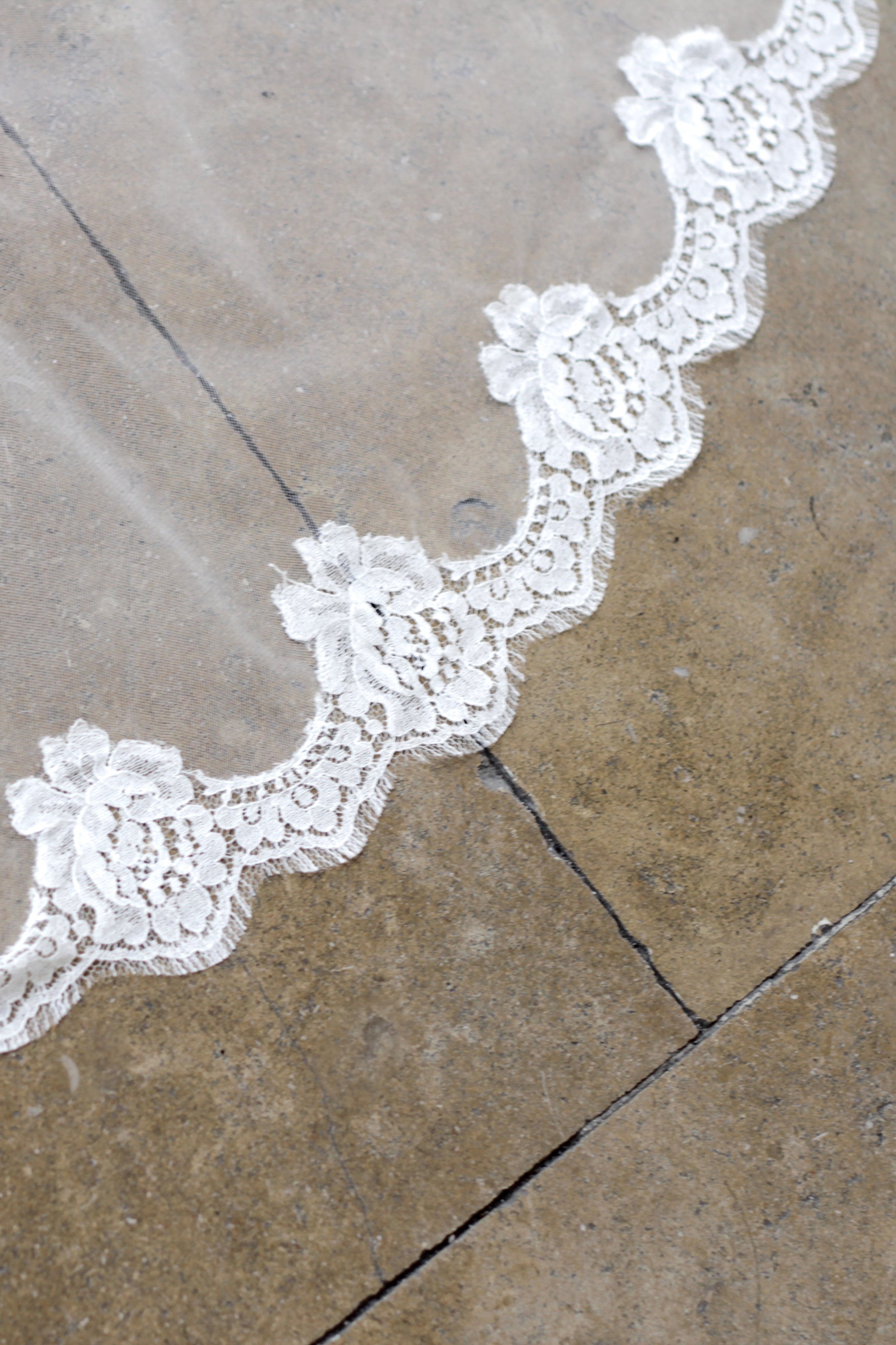 Handcrafted lace wedding veil with scalloped edge detail