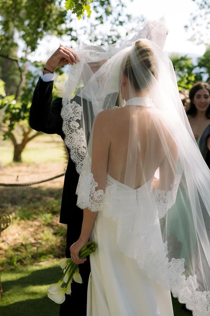 Groom is the person who lifts the veil at a wedding