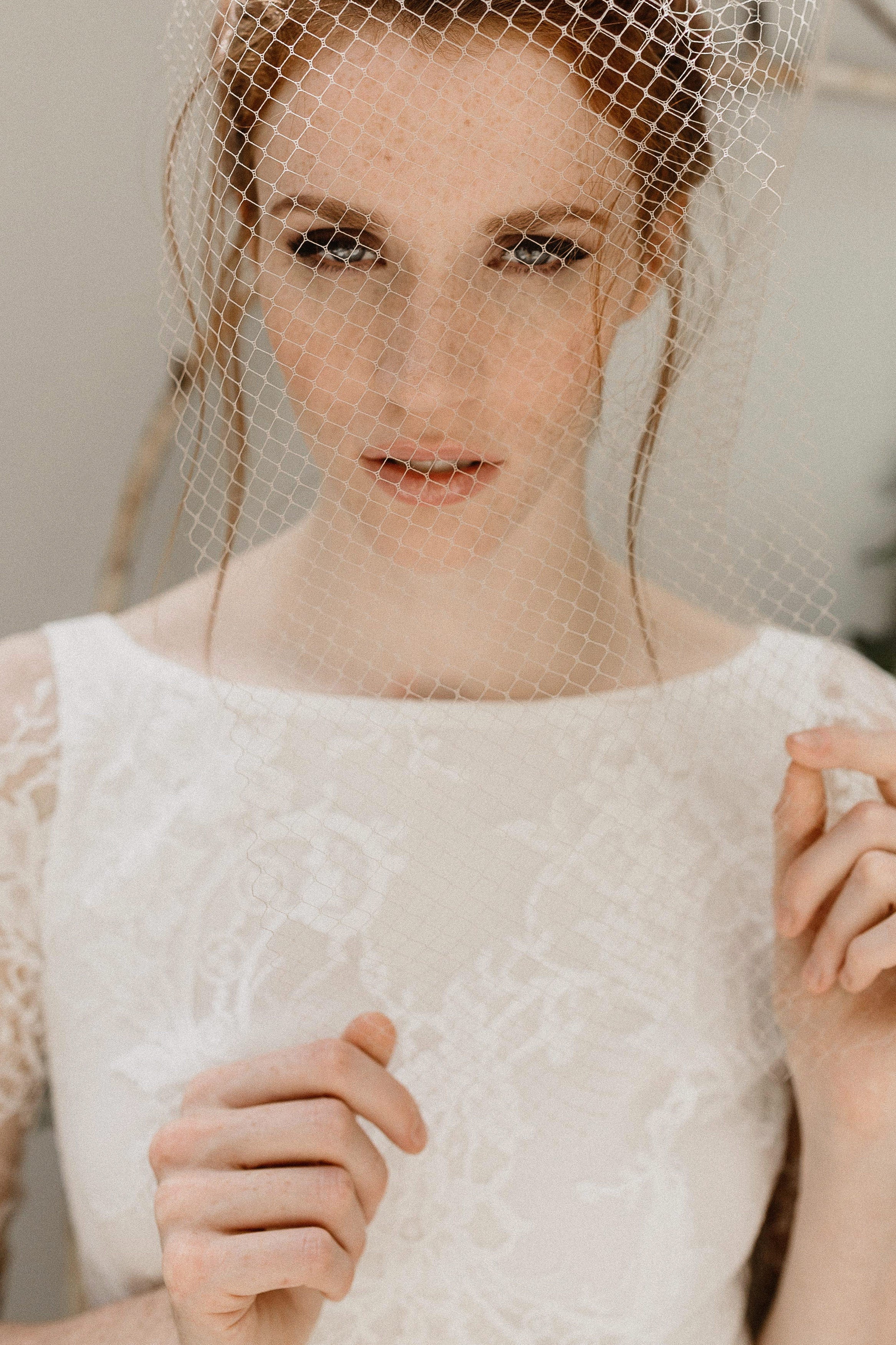Short bridal birdcage veil styled for city hall wedding look