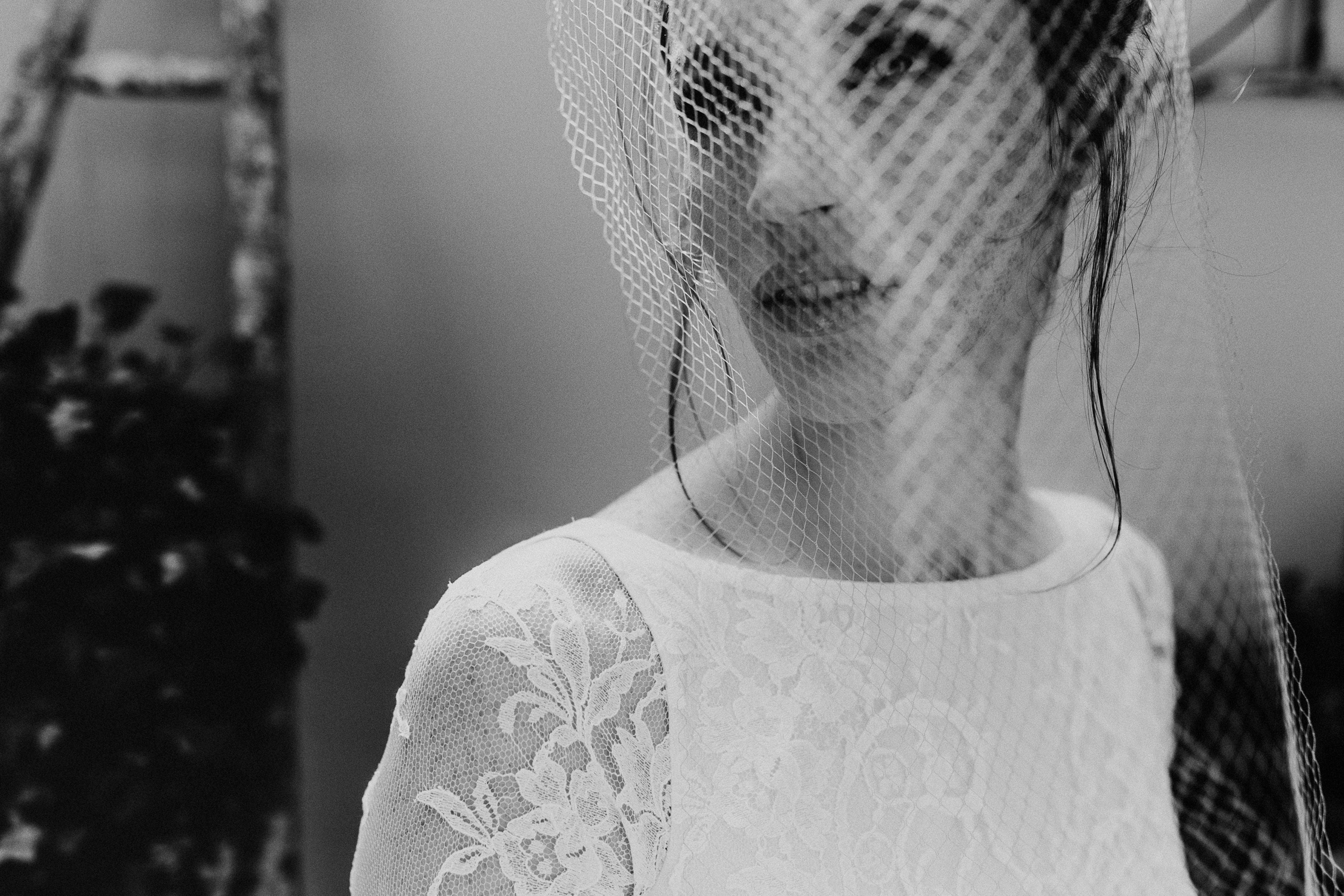 Close-up of birdcage veil on silver metal comb, handcrafted in Paris