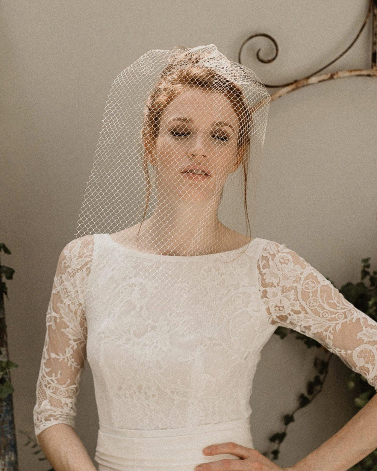 Bride wearing short birdcage veil voilette with soft French netting over eyes