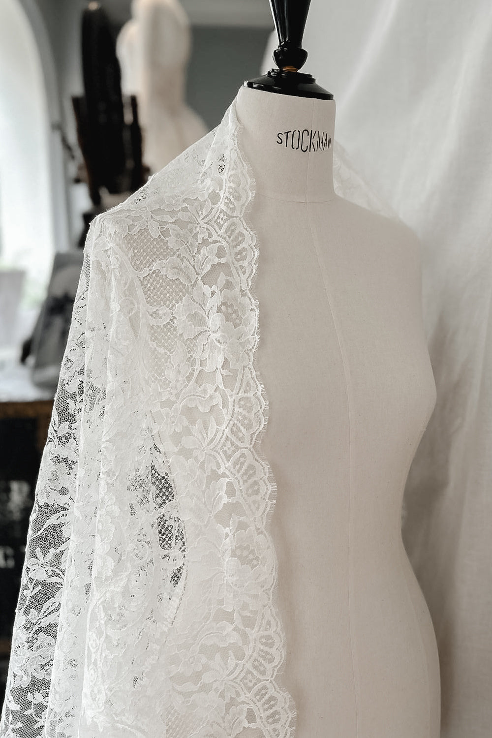 Wide lace border with small round medallions and flowing floral stems