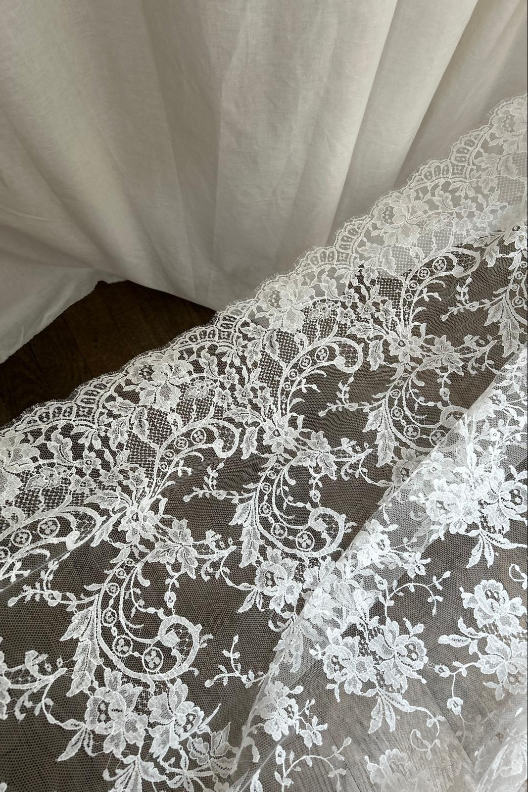 Scalloped eyelash edge of the lace falling over a Stockman Paris dress form