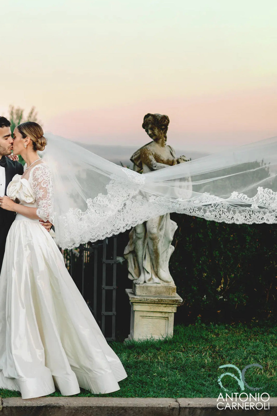 An ivory cathedral bridal veil in fine tulle with elegant embroidery worn in Roma