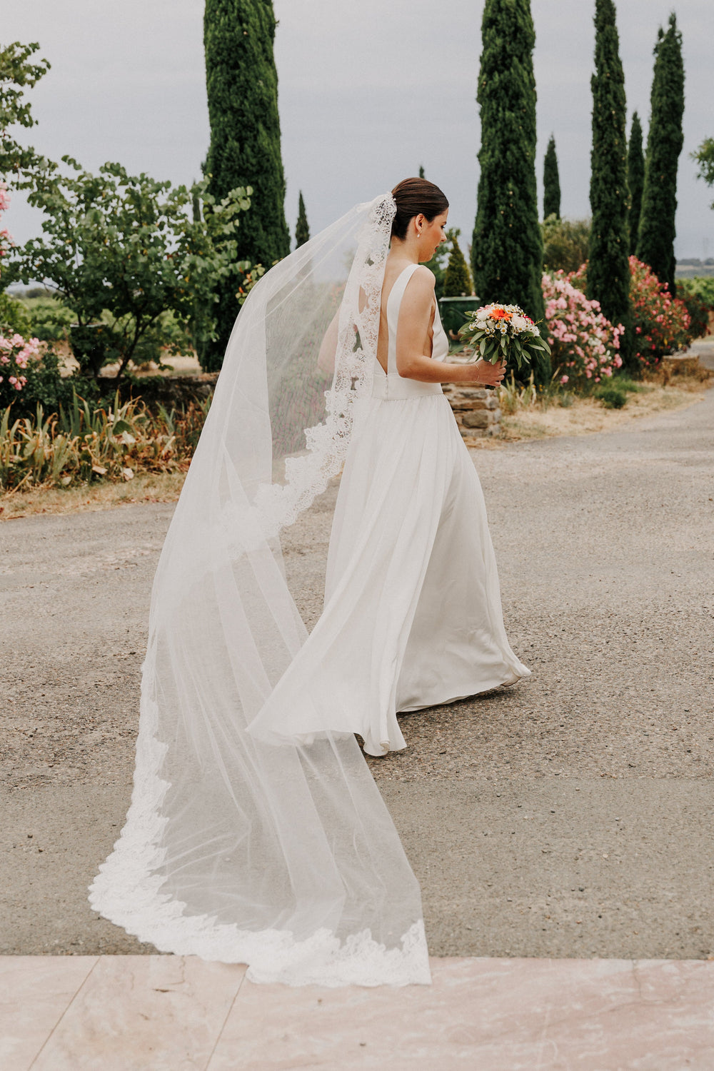 Traditional mantilla wedding veil with Calais lace trim, worn for church and ceremonial weddings