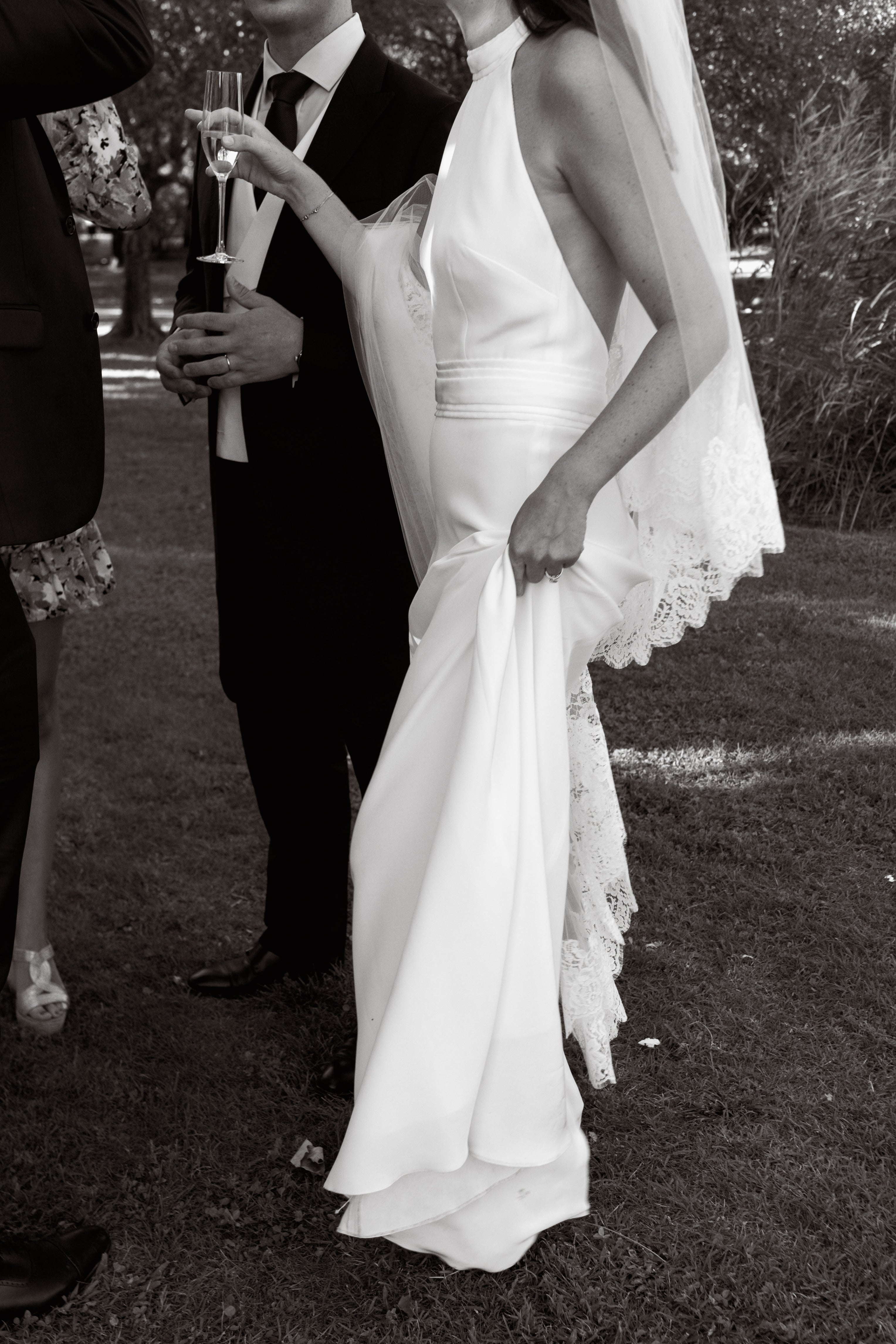 Bride walking after the ceremony wearing the Mon Amour lace bridal veil