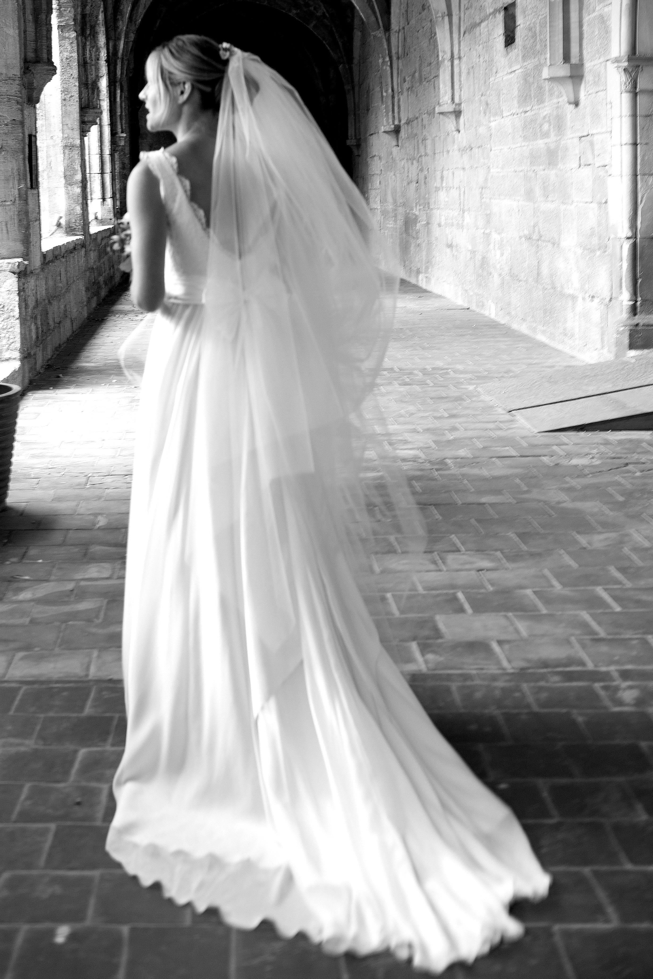 Bride wearing a short tulle wedding veil with a low bun hairstyle